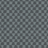 Detail of printed wallpaper in a watercolor ikat-inspired checkerboard pattern in tonal shades of charcoal-blue.