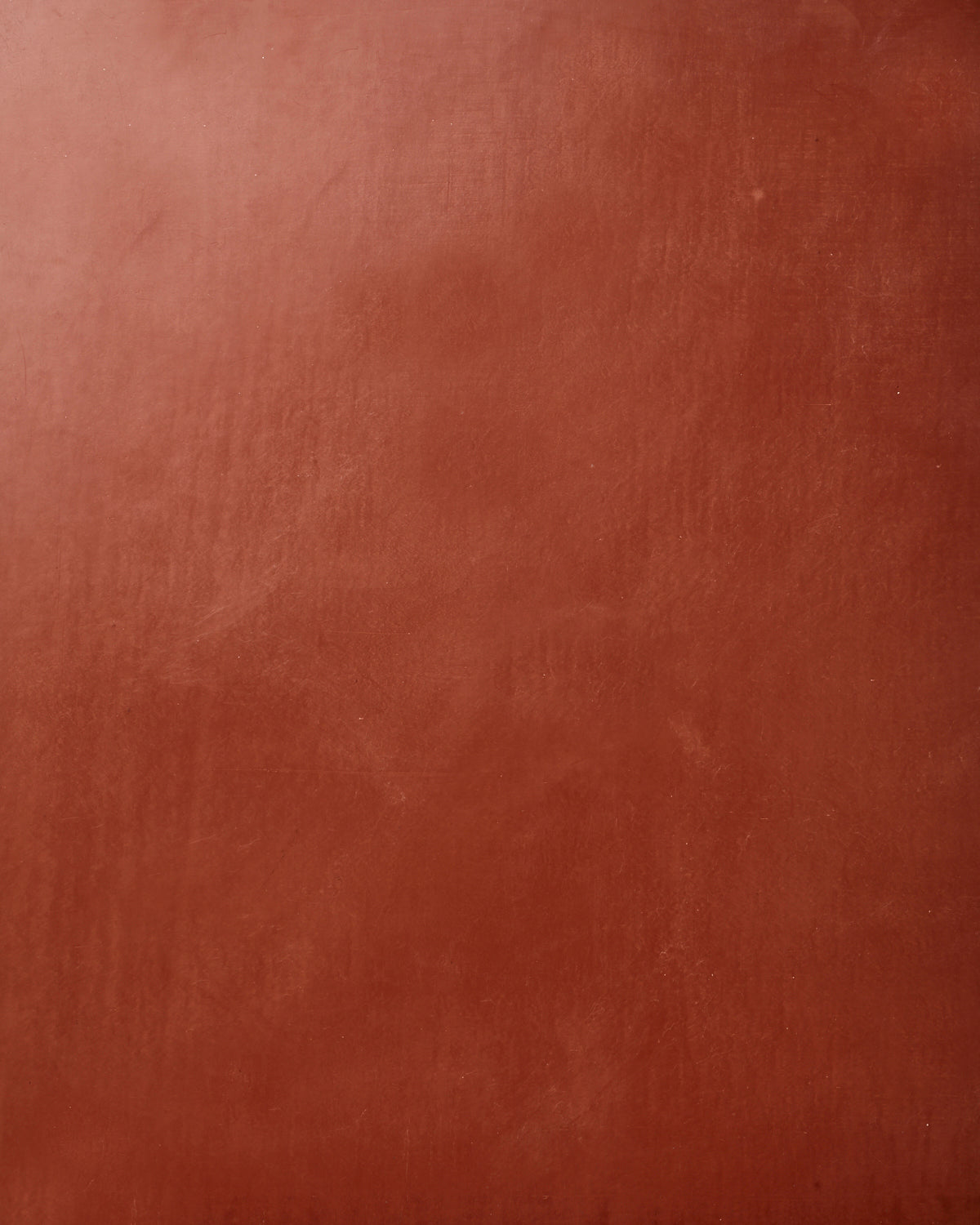 Detail of wallpaper in a glossy red-brown leather.