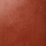 Detail of wallpaper in a glossy red-brown leather.