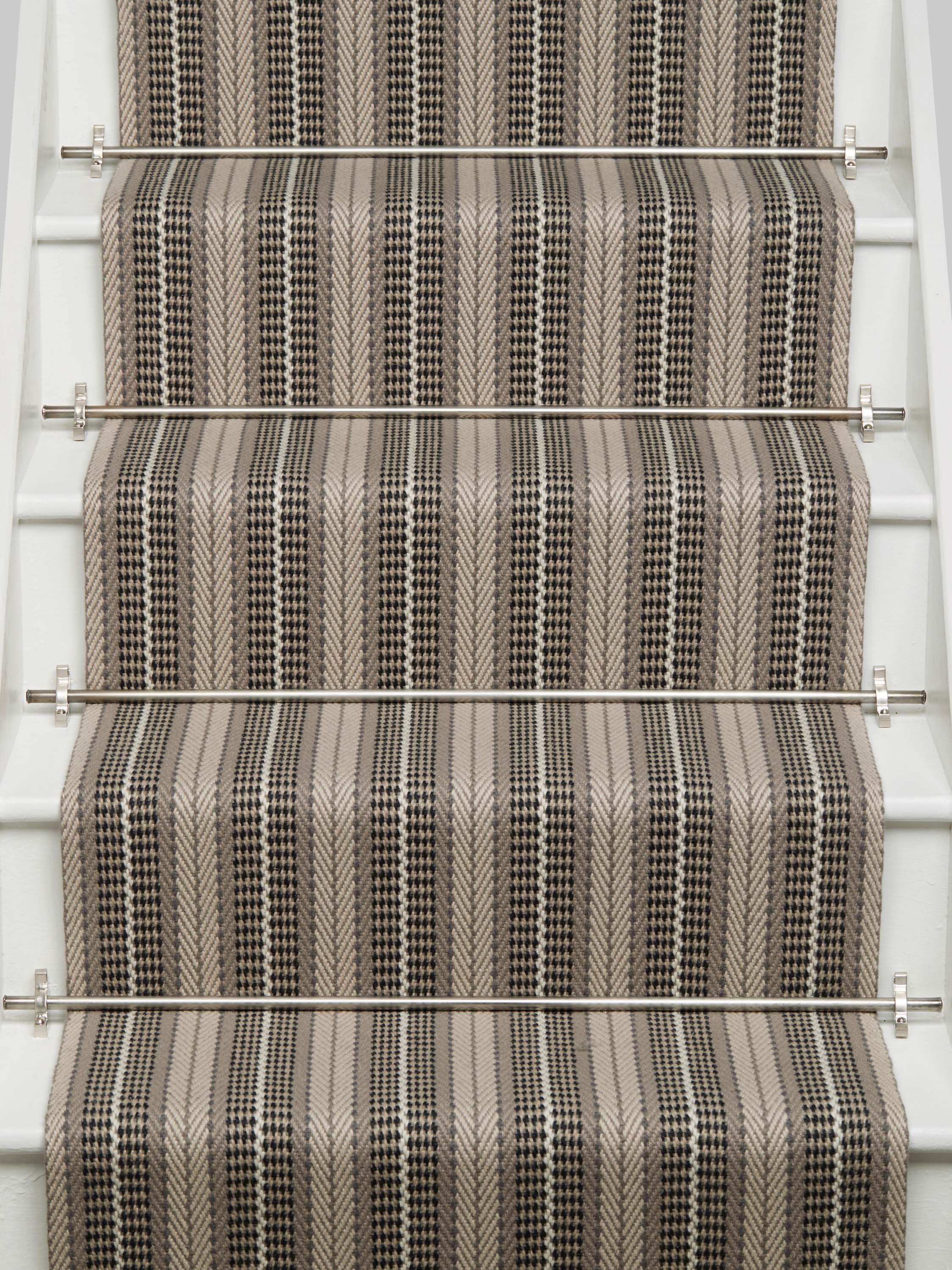 Striped flatweave runner in tan and black and white on white staircase