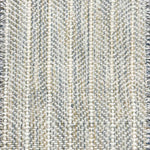 Close up of broadloom carpet with striated herringbone weave in white with accents of blue and green. 