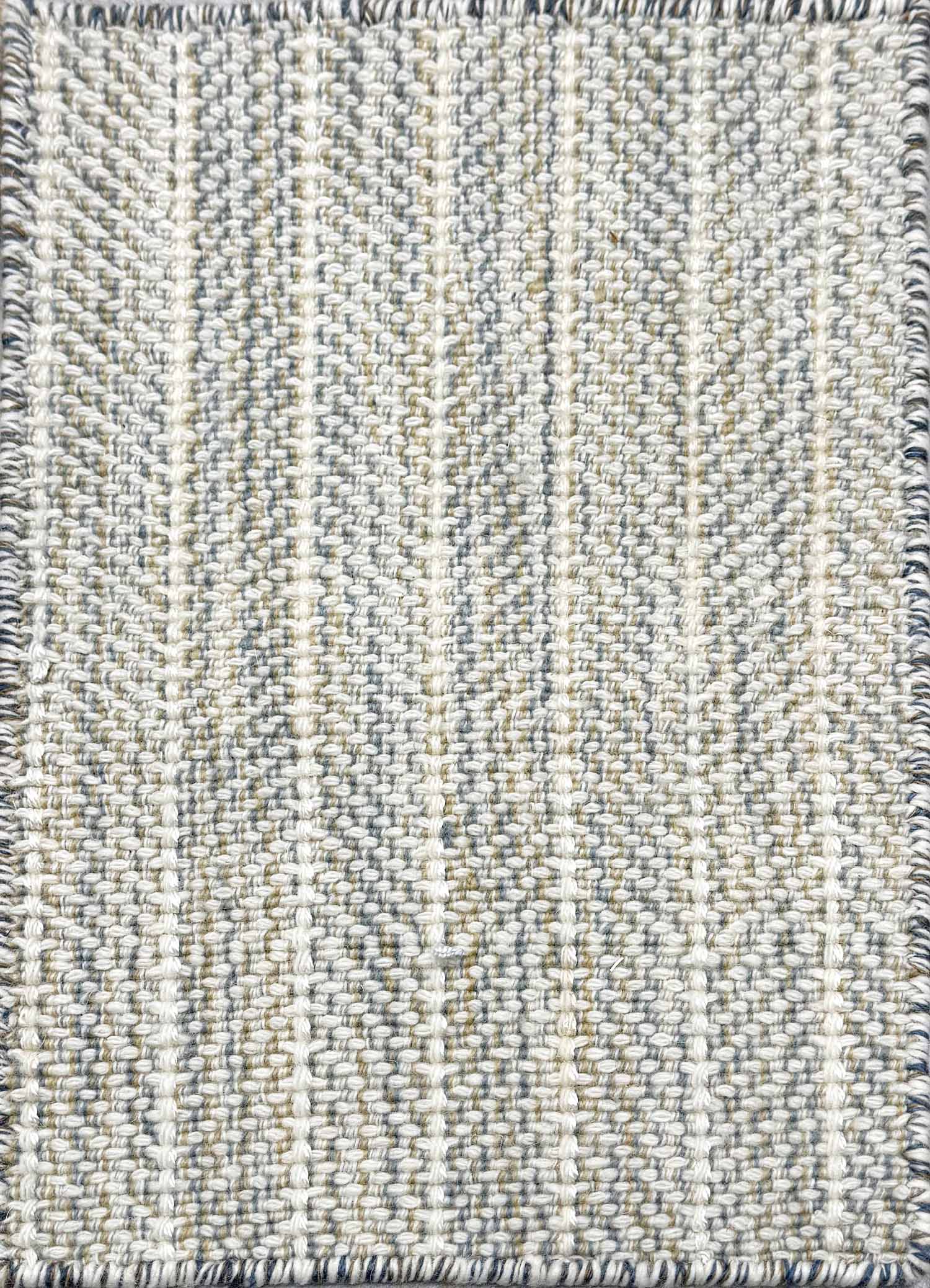 Close up of broadloom carpet with striated herringbone weave in white with accents of blue and green. 