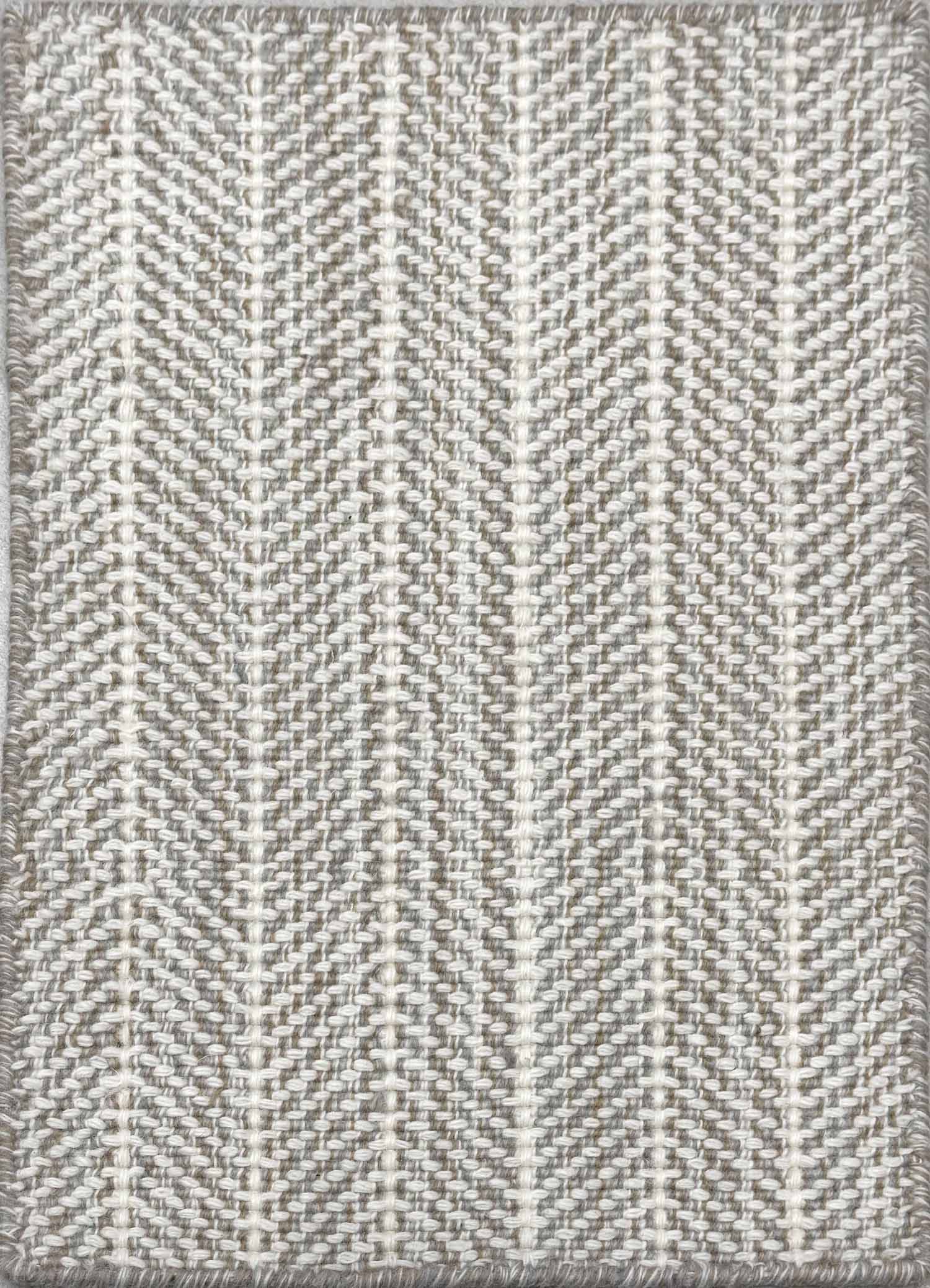 Close up of broadloom carpet with striated herringbone weave in white with accents of grey and taupe.