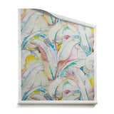 A roll of wallpaper with watercolor banana-leaf pattern in white, blush pink, teal, yellow, and soft blue on a warm cream background.