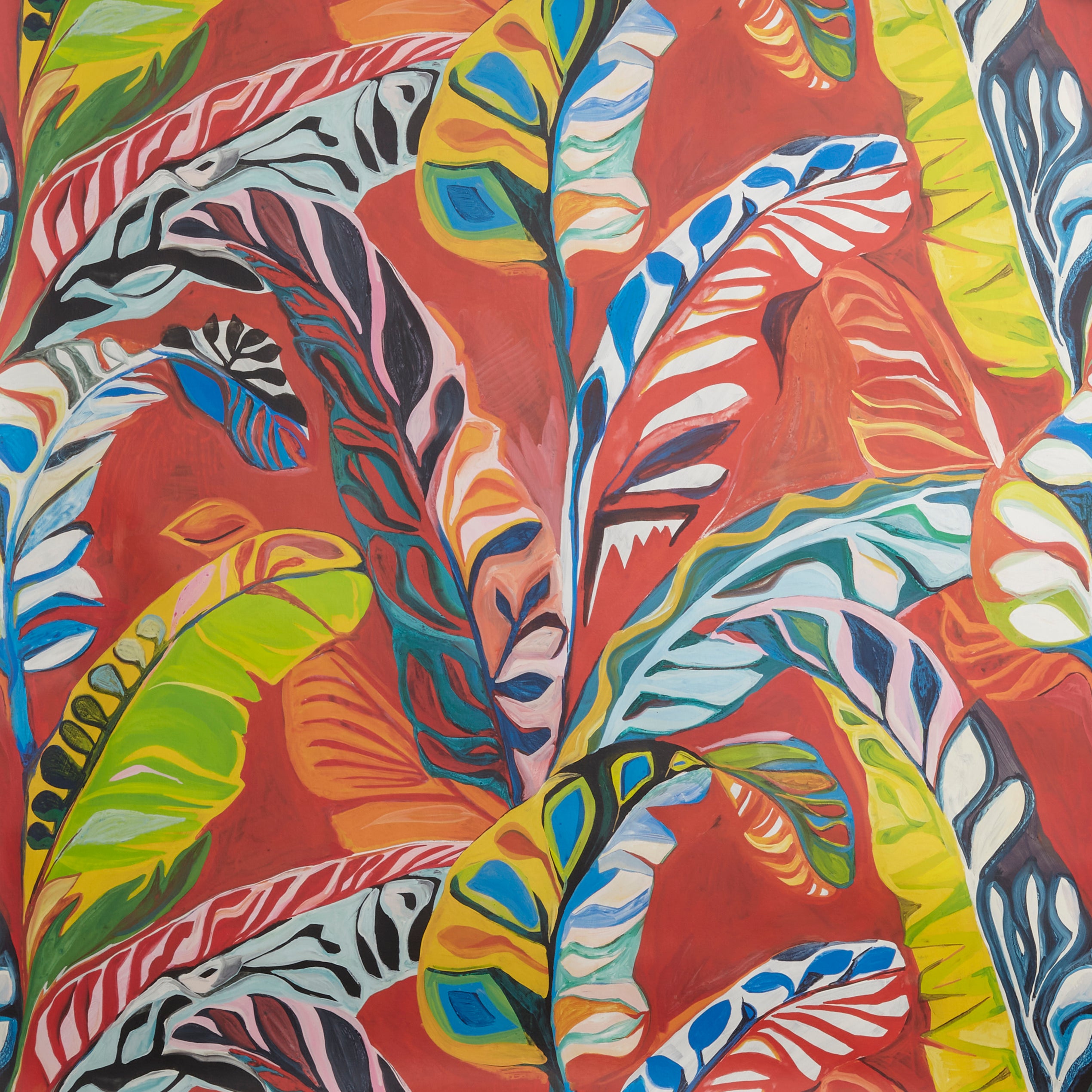 Close up of wallpaper with expressive painterly banana-leaf pattern in red, yellow, green, pink and blue on a red field. 