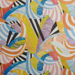 Close up of wallpaper with an abstract striped banana-leaf pattern in yellow, orange, blue, purple and black and white. 