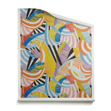 A roll of wallpaper with an abstract striped banana-leaf pattern in yellow, orange, blue, purple and black and white. 