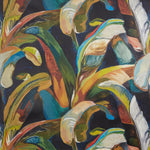 Close up of wallpaper with a gestural painted banana leaf pattern in yellow, blue, green, white and orange on a navy blue field. 