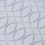Detail of a wallpaper in a playful floral lattice print in navy blue and tan on a white field.