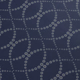 Detail of a wallpaper in a playful floral lattice print in white and tan on a navy blue field.