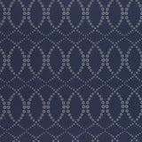Wallpaper in a playful floral lattice print in white and tan on a navy blue field.