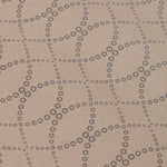Detail of a wallpaper in a playful floral lattice print in tan and navy on a taupe field.