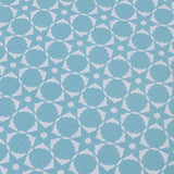 Wallpaper detail in a floral lattice print in  cream on a powder blue field.