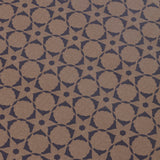 Wallpaper detail in a floral lattice print in navy on a kraft brown field