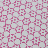 Wallpaper detail in a floral lattice print in magenta on a cream field.