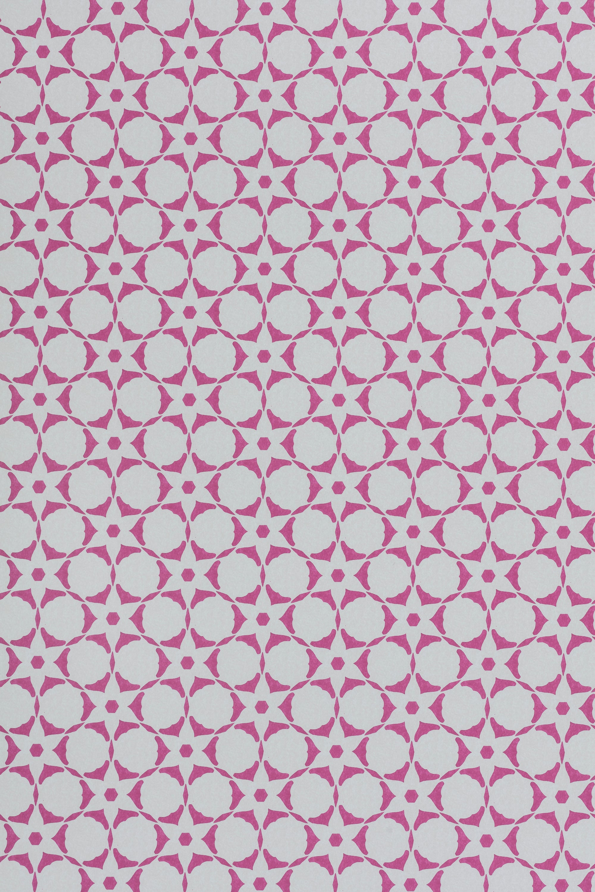 Wallpaper in a floral lattice print in magenta on a cream field.