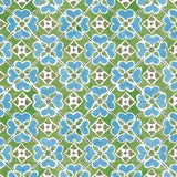 Detail of wallpaper in a floral lattice print in blue, green, brown and white.