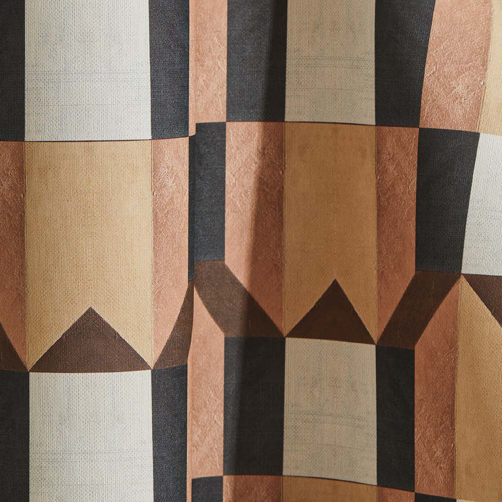 Draped wallpaper yardage in geometric grid print in shades of pink, brown and gray on a white field.