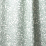 Draped linen in  an abstract leaf pattern in white on a pale aqua watercolor field.