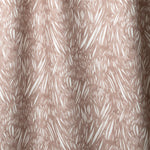 Draped linen in  an abstract leaf pattern in white on a warm brown watercolor field.