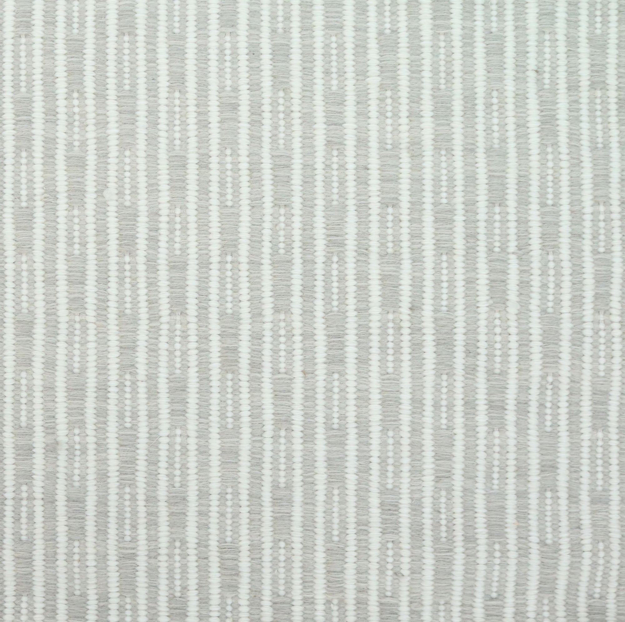 Flatweave rug in a solid and dashed stripe in cream on pale ecru field