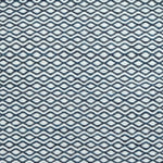 Flatweave rug in a small scale zigzag dot stripe in cream on a navy blue field.