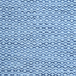 Flatweave rug in a small scale zigzag dot stripe in cream on a heather blue field.