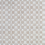 Flatweave rug in a small scale decorative lattice design in cream on a tan field. 