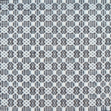 Flatweave rug in a small scale decorative lattice design in cream on a dark grey field. 