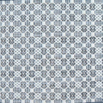 Flatweave rug in a small scale decorative lattice design in cream on a chambray blue field.