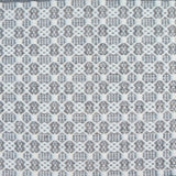 Flatweave rug in a small scale decorative lattice design in cream on a cool grey field. 