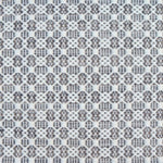 Flatweave rug in a small scale decorative lattice design in cream on a slate grey field