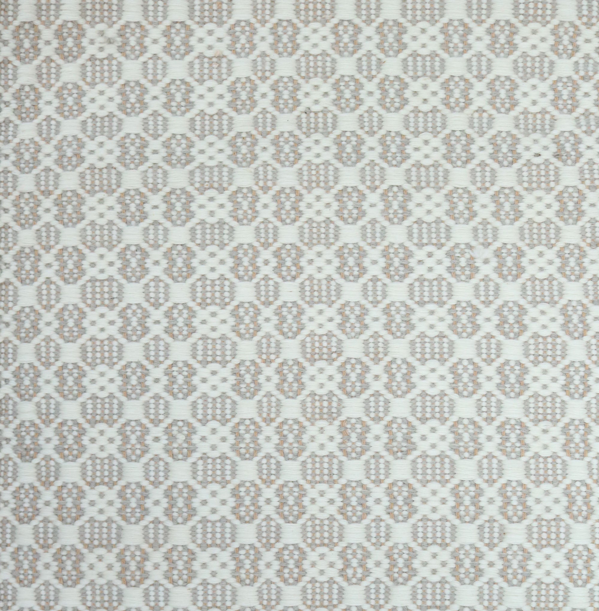 Flatweave rug in a small scale decorative lattice design in cream on a grey and tan field. 