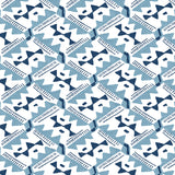 Detail of wallpaper in painterly diamond print in blue and navy on a white field.