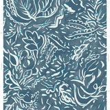Detail of wallpaper in a painterly botanical print in white and blue on a navy field.