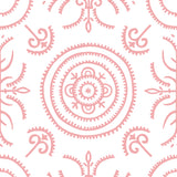 Detail of wallpaper in a playful medallion print in light pink on a white field.