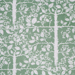 White tree and leaf design on a green field. 