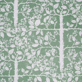 White tree and leaf design on a green field. 