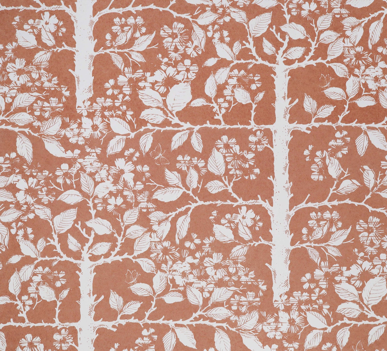 White tree and leaf design on a warm red field. 