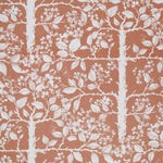 White tree and leaf design on a warm red field. 