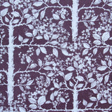 Detail of wallpaper in a large-scale tree and leaf print in white on a dark plum field.