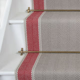 Striped herringbone in grey and red on white staircase