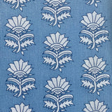 Detail of fabric in a repeating thistle print in navy and light blue on a blue field.