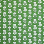 Detail of fabric in a repeating thistle print in white and green on a green field.