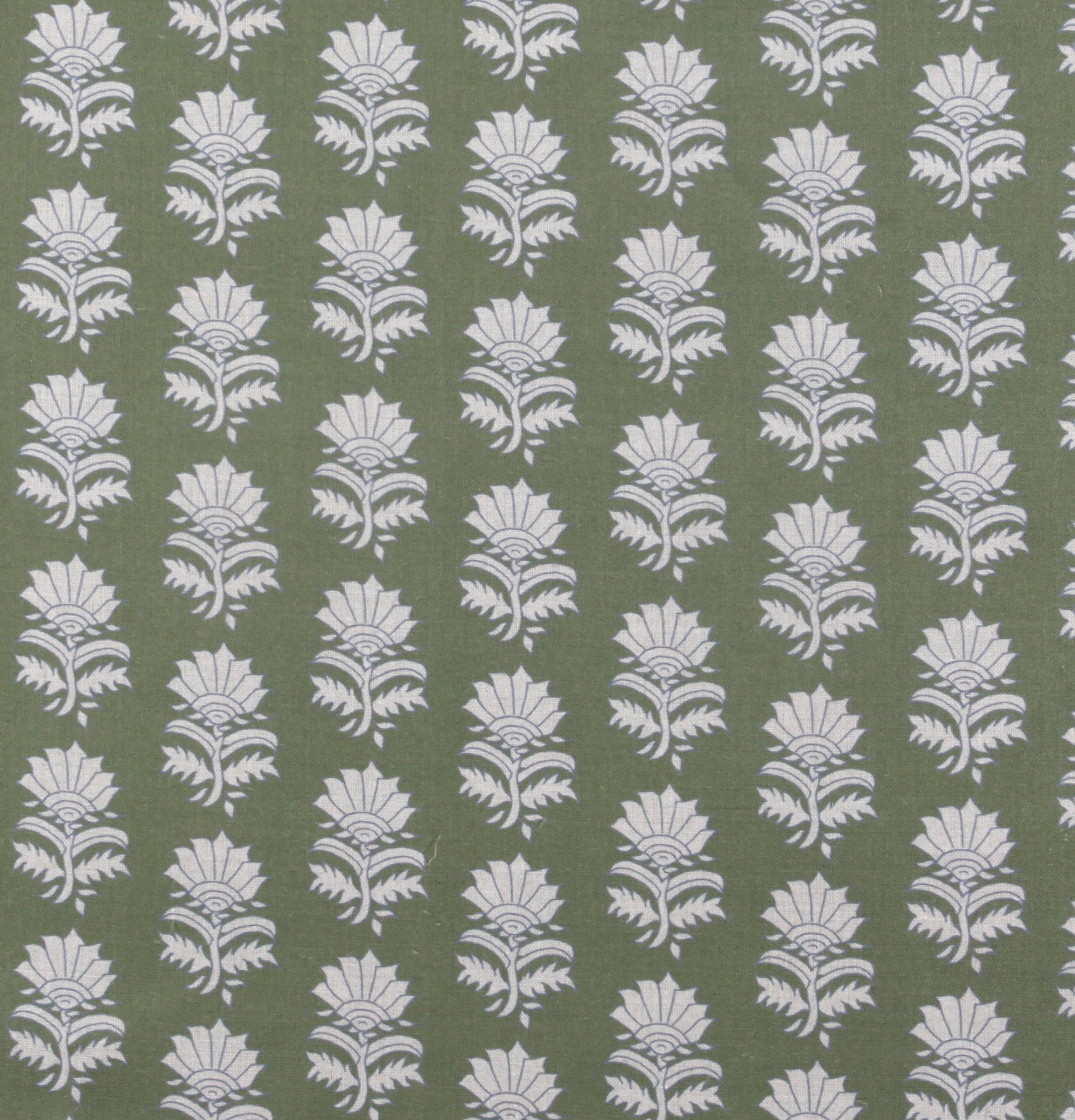 Detail of fabric in a repeating thistle print in white and blue on a green field.