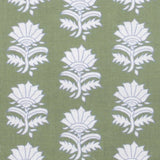 Detail of fabric in a repeating thistle print in white and blue on a green field.