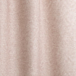 Gently draped fabric in a textural wicker pattern in blush pink on a white field. 