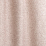 Gently draped fabric in a textural wicker pattern in blush pink on a white field. 
