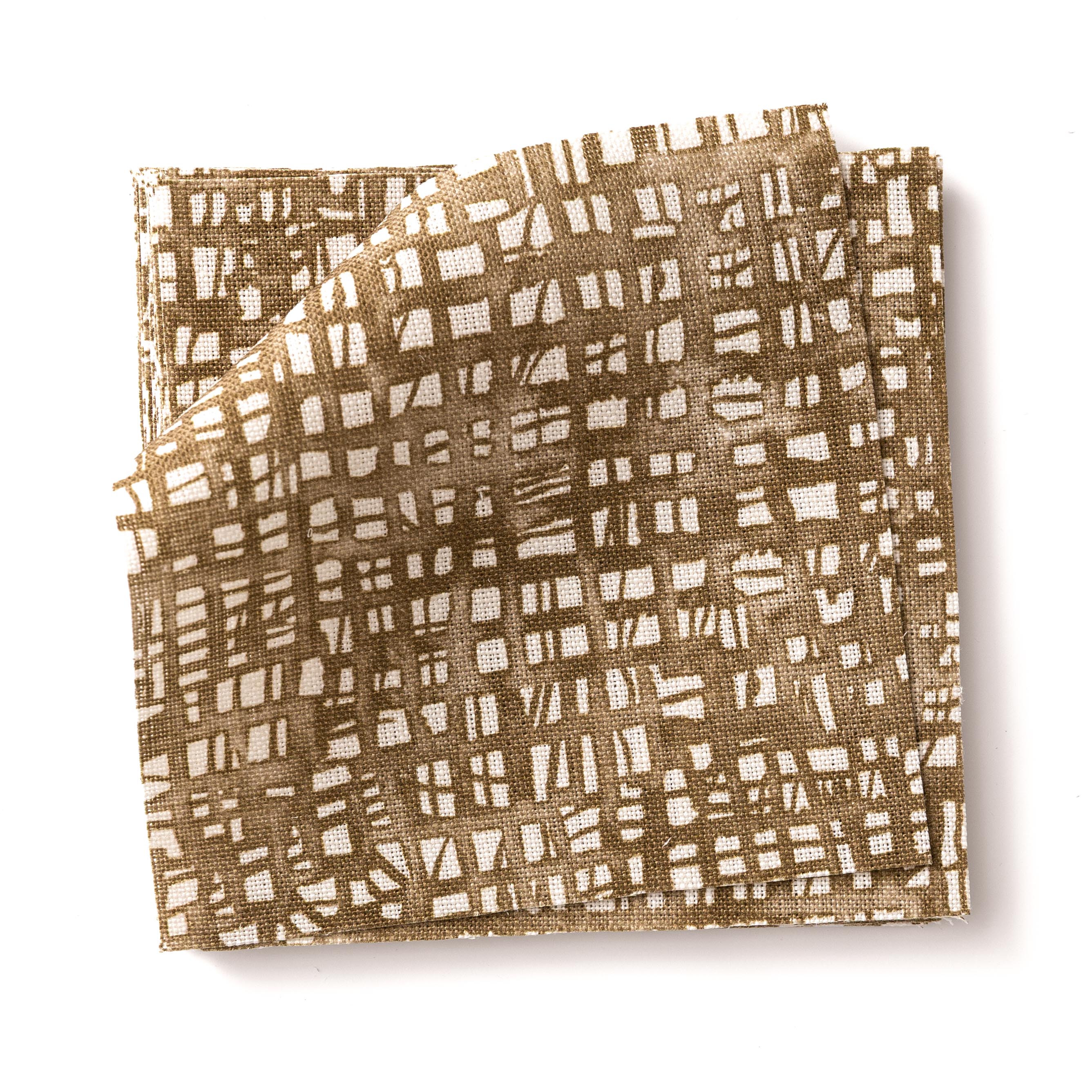Stacked swatches of fabric in a textural wicker pattern in warm brown on a white field. 