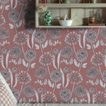 Cozy reading nook with a decorative wooden shelf against a pink floral wallpaper. 